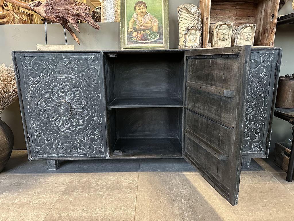 Zwart dressoir met handgesneden mandala's in de deurtjes.